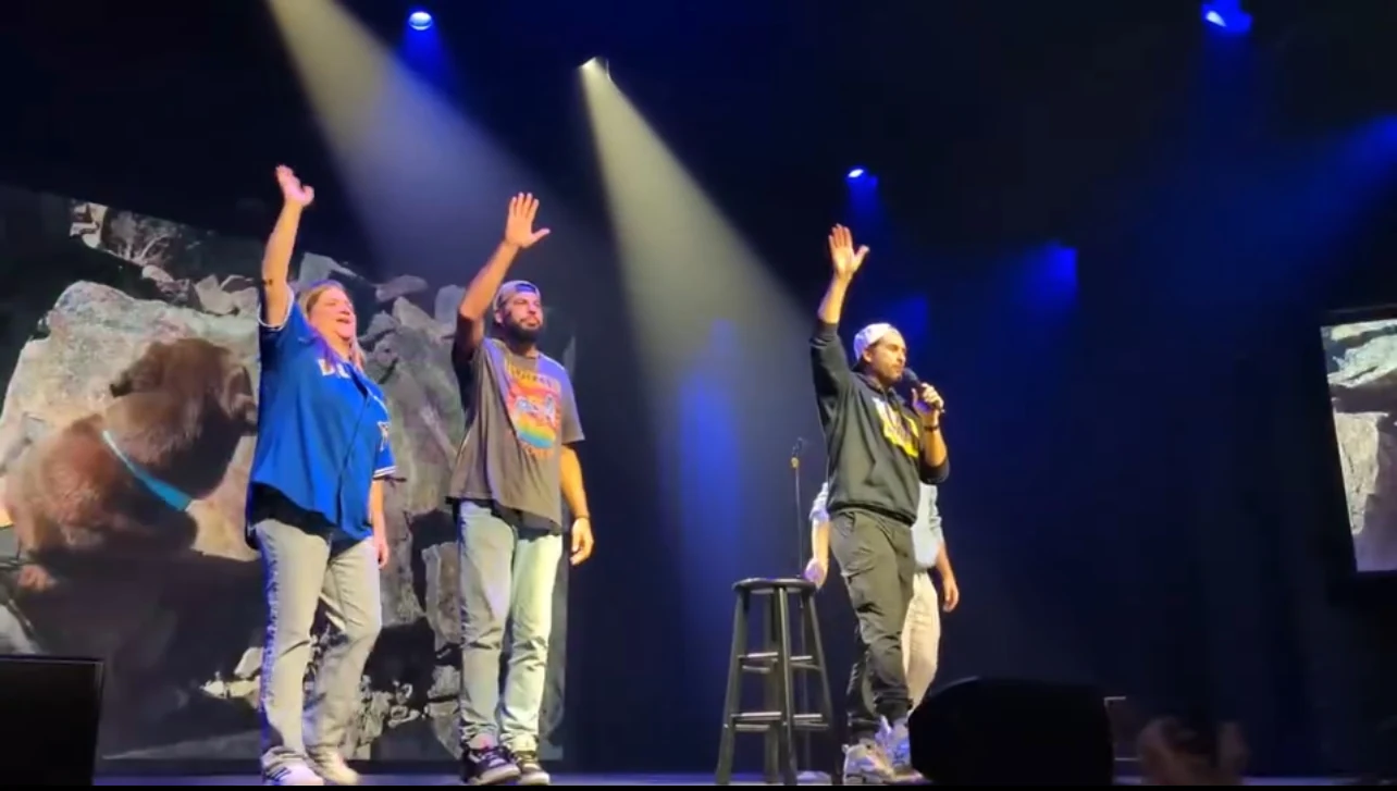 The performers waving goodbye from the stage