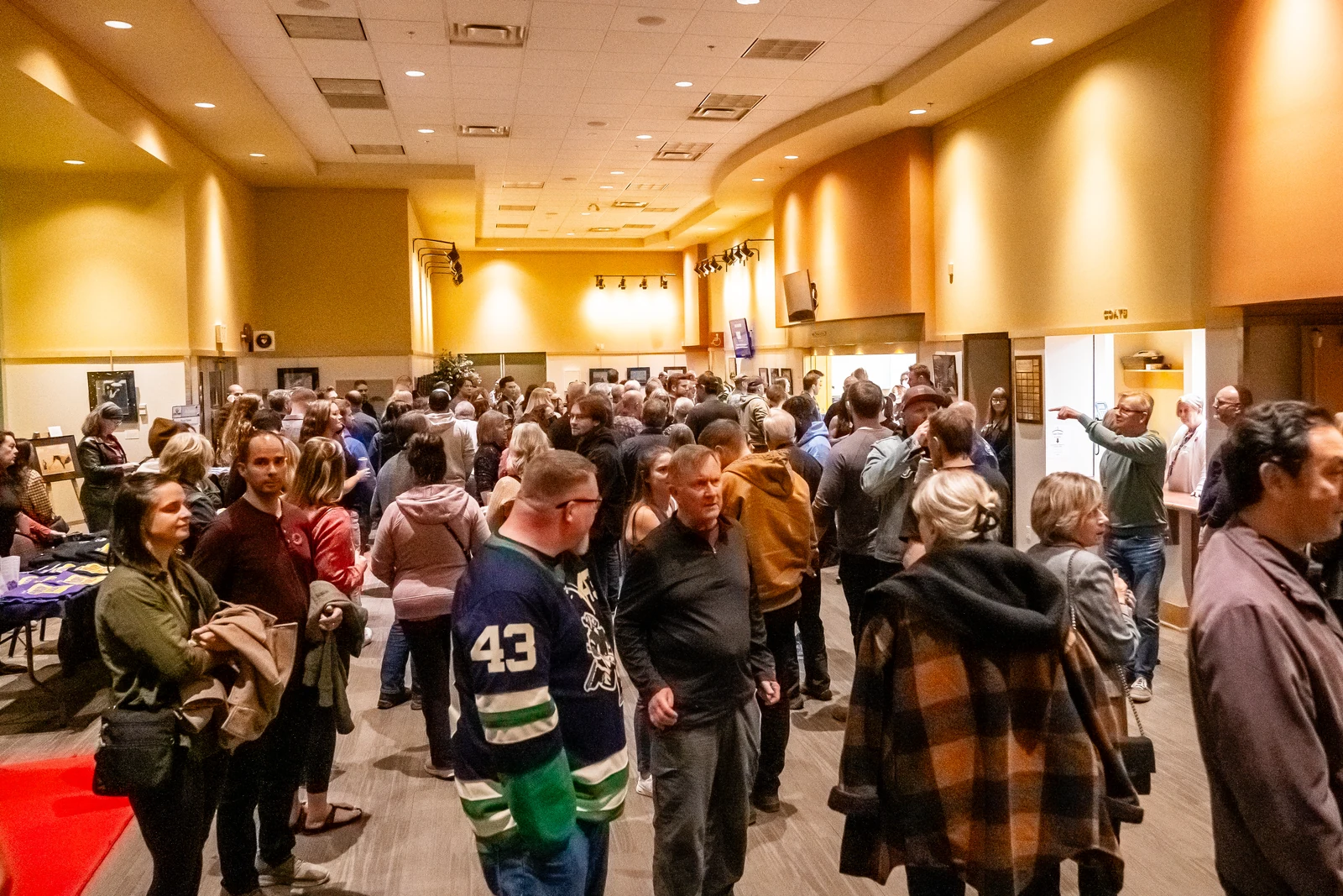Audience members gathering in the theatre lobby