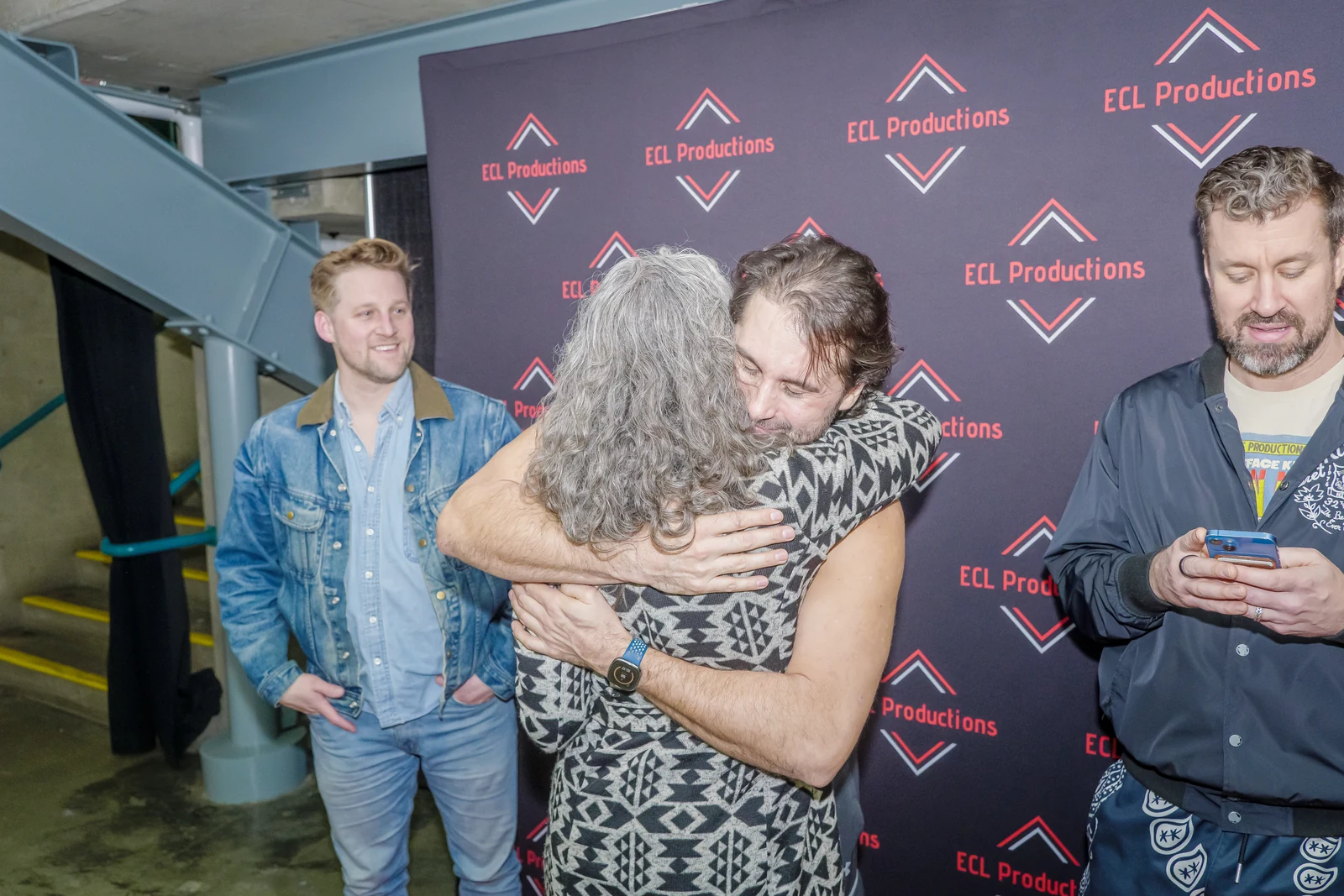 A performer embracing a guest at the photo backdrop