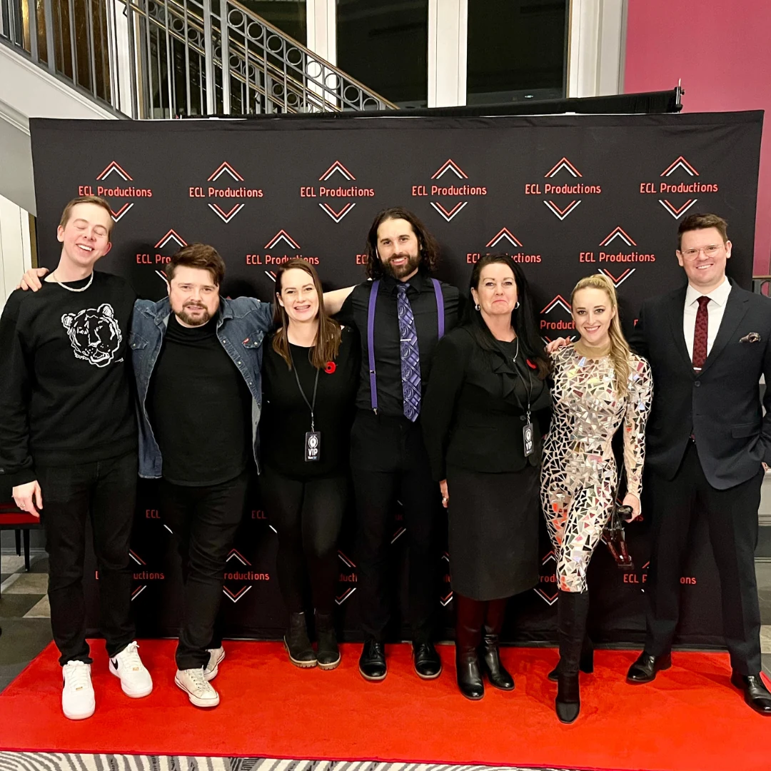 The tour crew posing at the ECL Productions photo backdrop