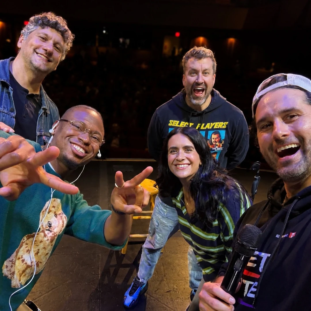 The tour crew taking a selfie on stage