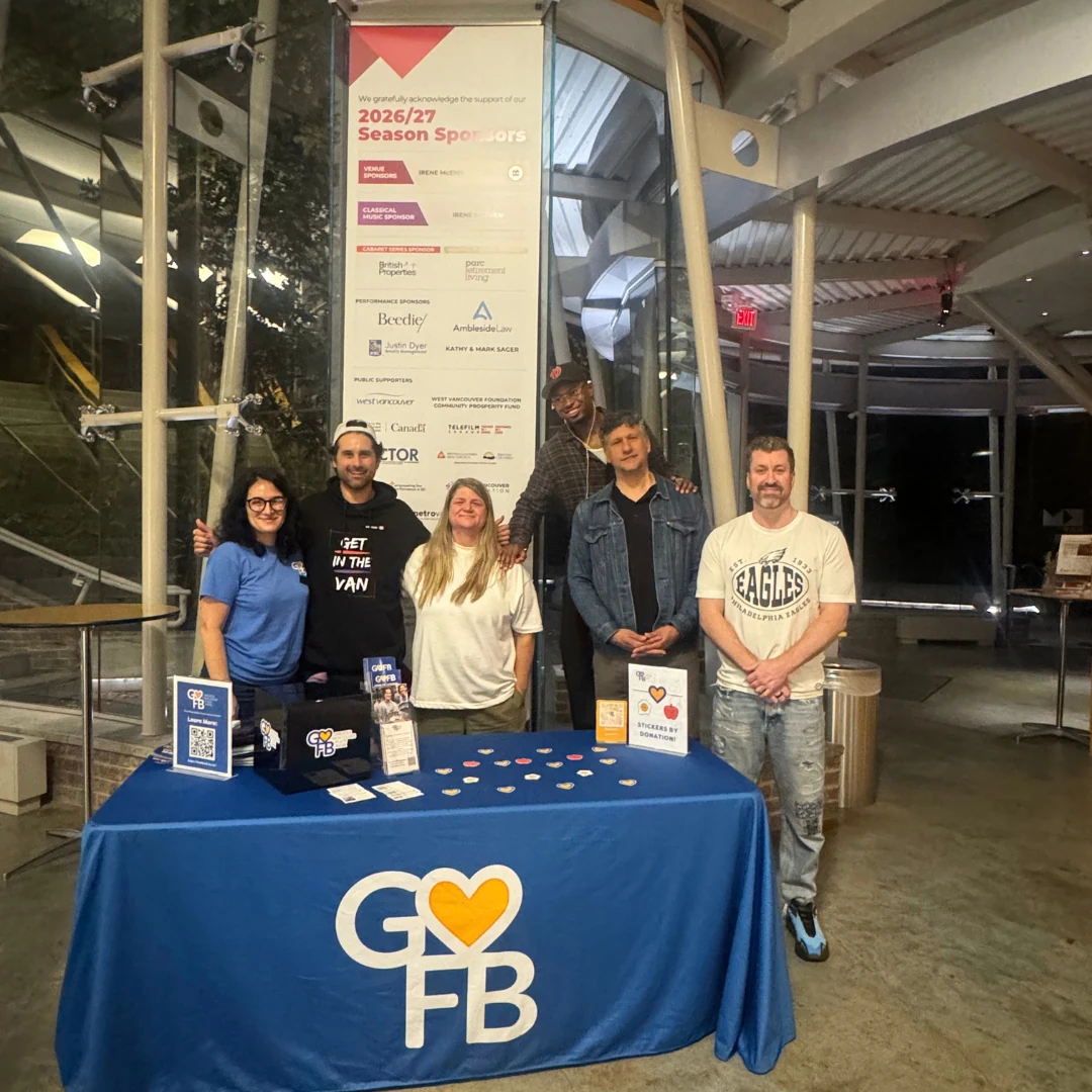 The tour crew with the Greater Vancouver Food Bank donation table